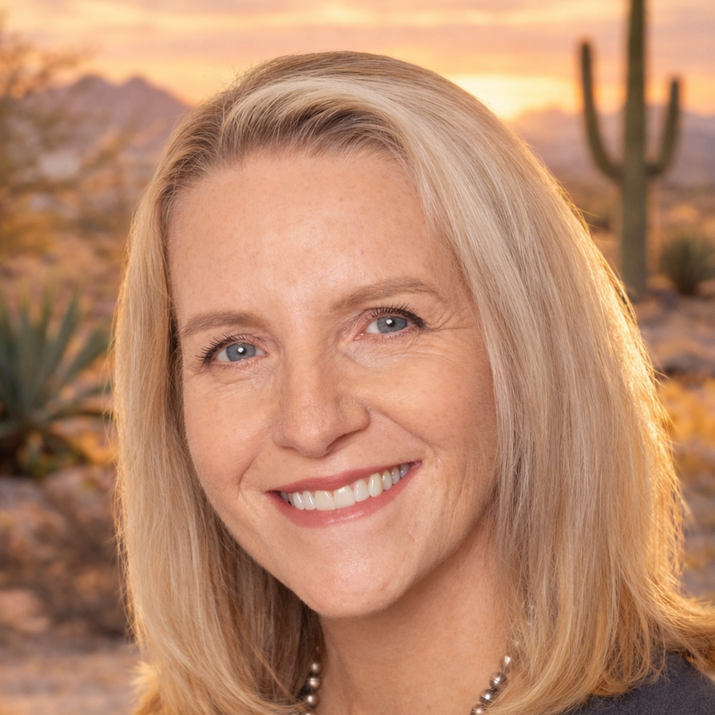 Headshot of Tammy Allgood Wolf - Smiling woman against desert sunset backdrop